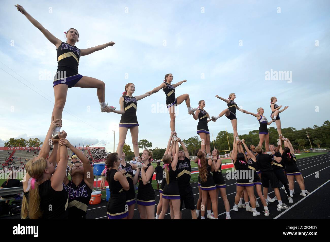 Winter Springs cheerleaders perform before a high school football game ...