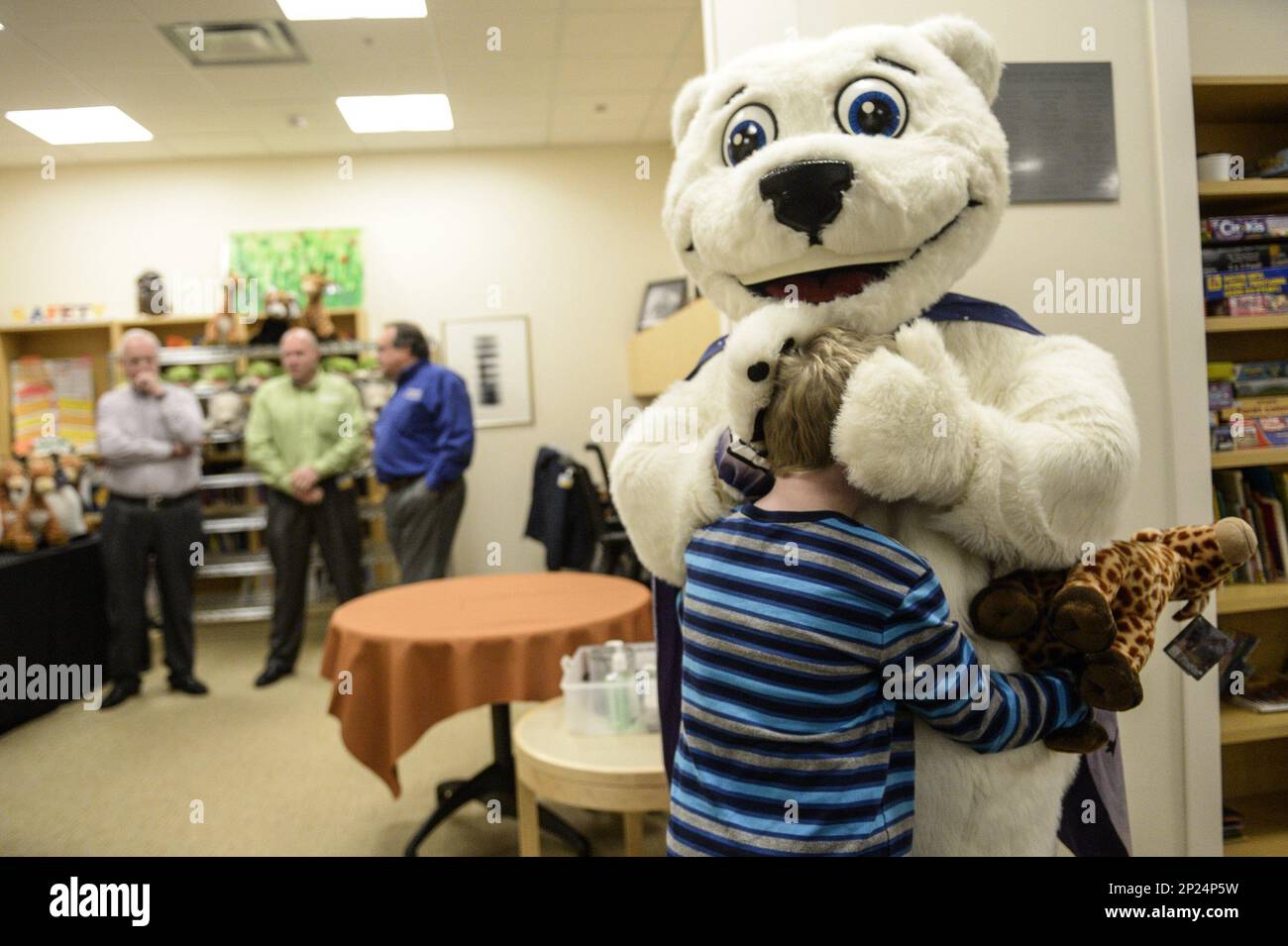 Liam Sullivan, 8, hugs the Detroit Zoo polar bear mascot after