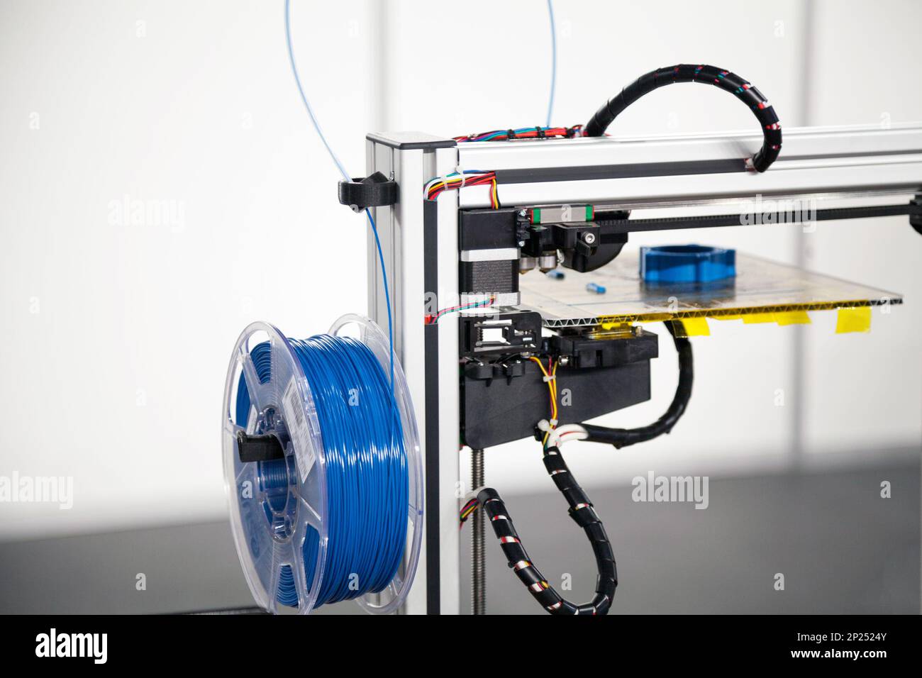 3d printer with blue filament coil close-up. 3d printing process technology Stock Photo