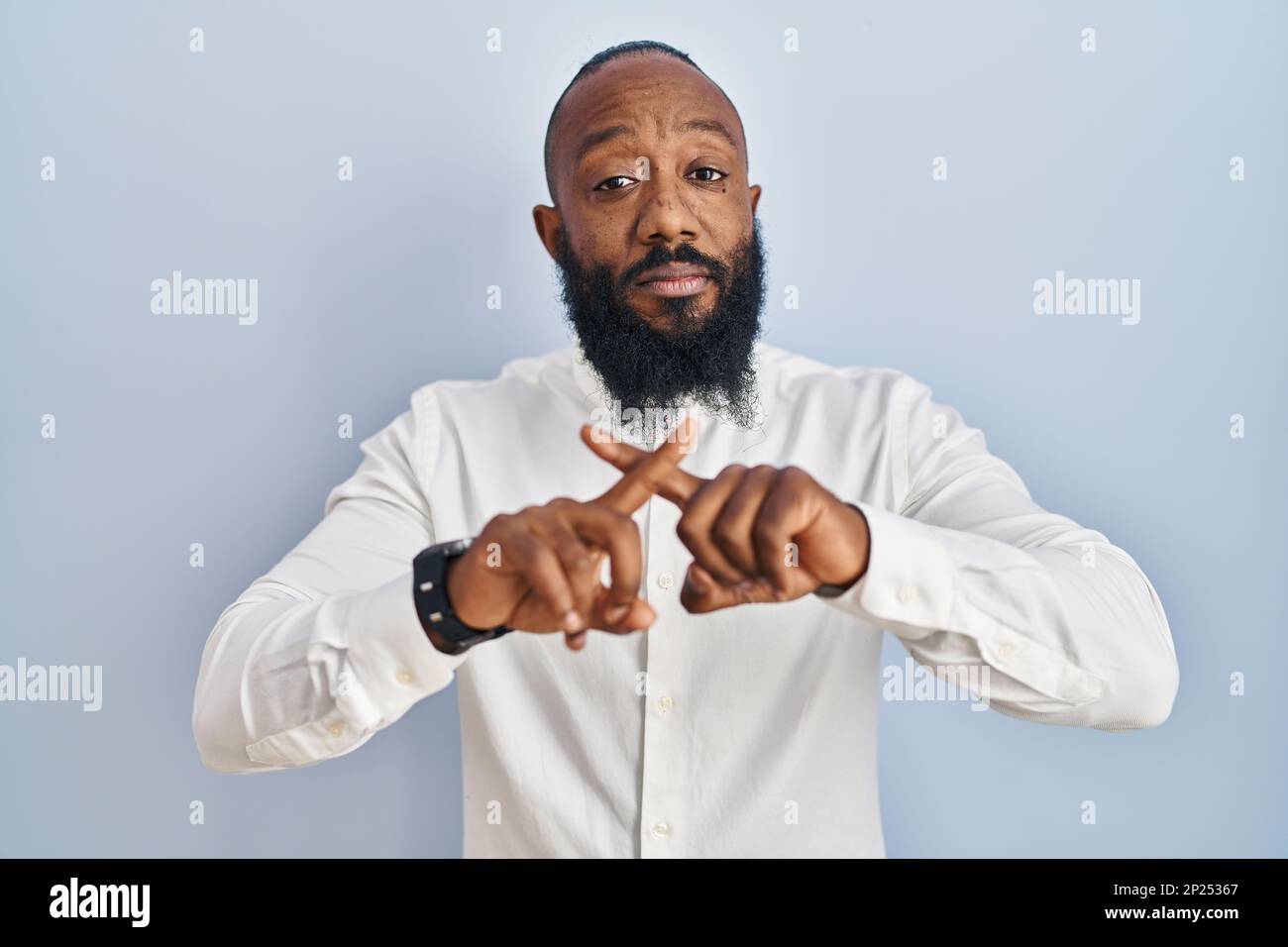 African american man standing over blue background rejection expression ...