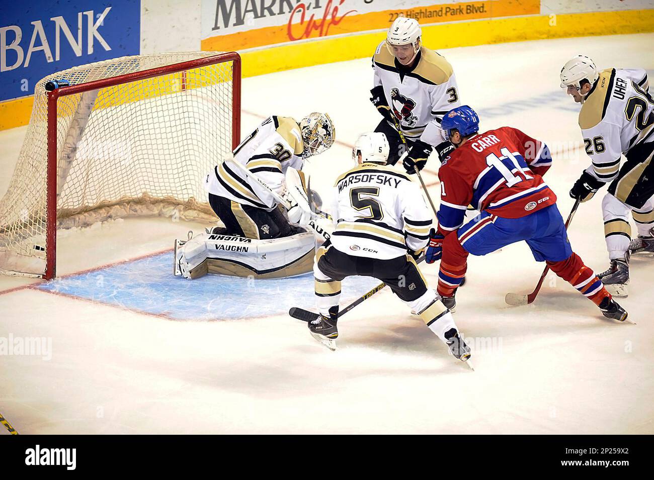 St John's IceCaps Daniel Carr (11) shoots between Wilkes-Barre/Scranton  Penguins' David Warsofsky (5), Reid McNeill (3) and Dominik Uher (26) and  scores on goalie Matt Murray (30) during the first period off