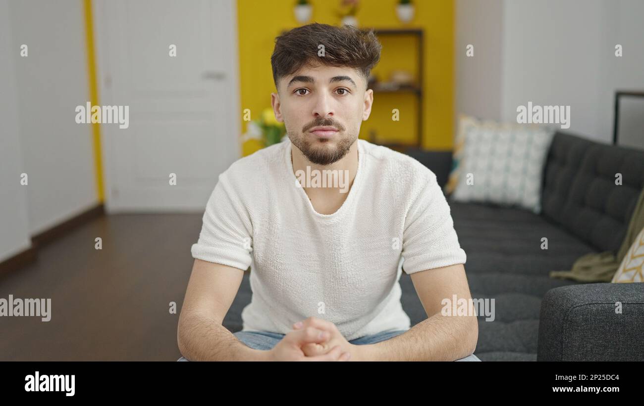 Arab man sitting on sofa hi-res stock photography and images - Alamy