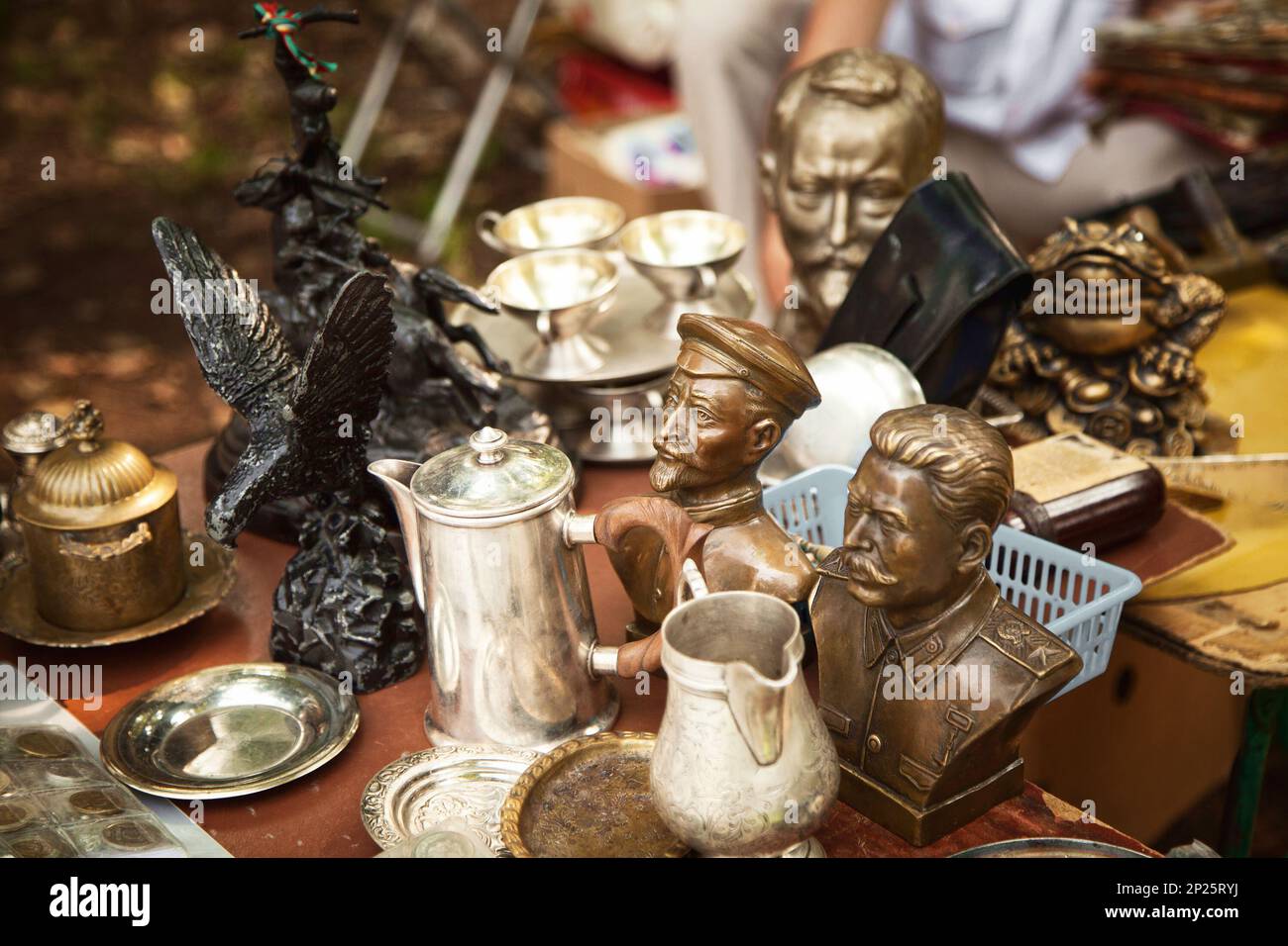 Khabarovsk, Russia - July 27, 2014: USSR famous historic persons busts and metal tableware at a flea market. Many old vintage things at a garage sale Stock Photo