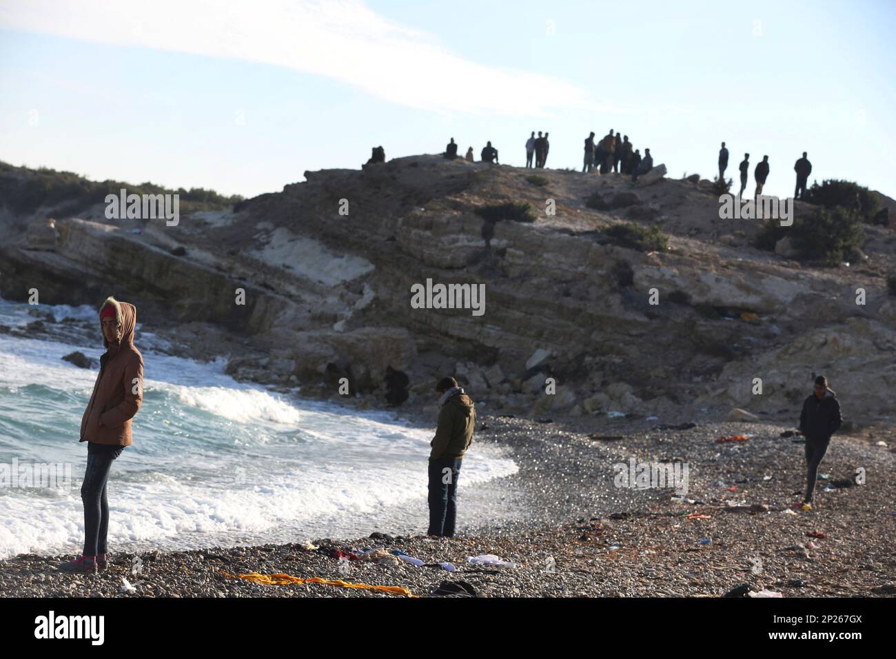 Migrants and refugees watch the rough sea as they wait to cross to the  Greek island of Chios, near Cesme, Turkey, Sunday, Nov. 1, 2015. Greek  authorities recovered more bodies on the