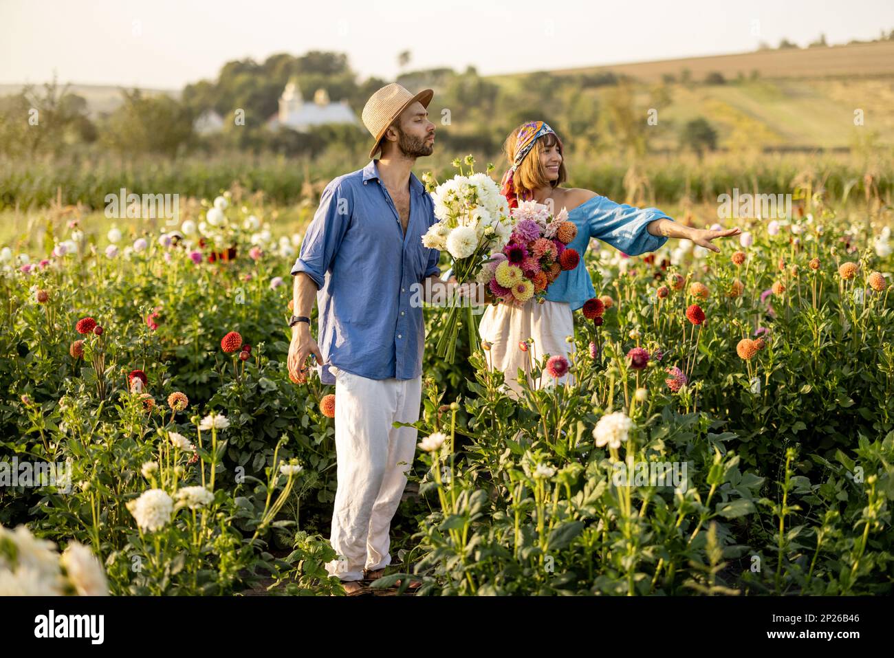 Man and woman pick up flowers at farm outdoors Stock Photo Alamy