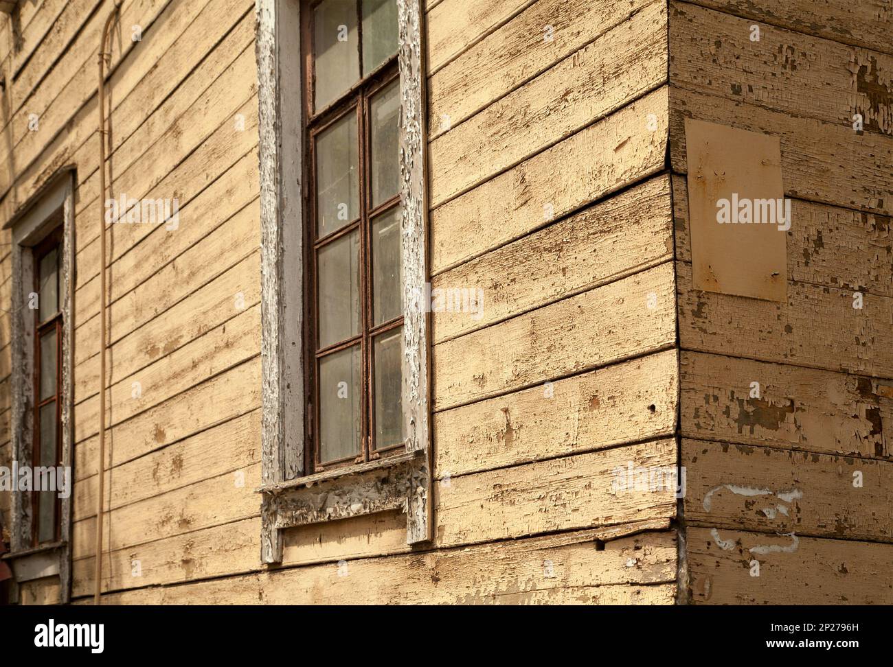 Old shabby beige wooden house close-up background. Weathered walls ...