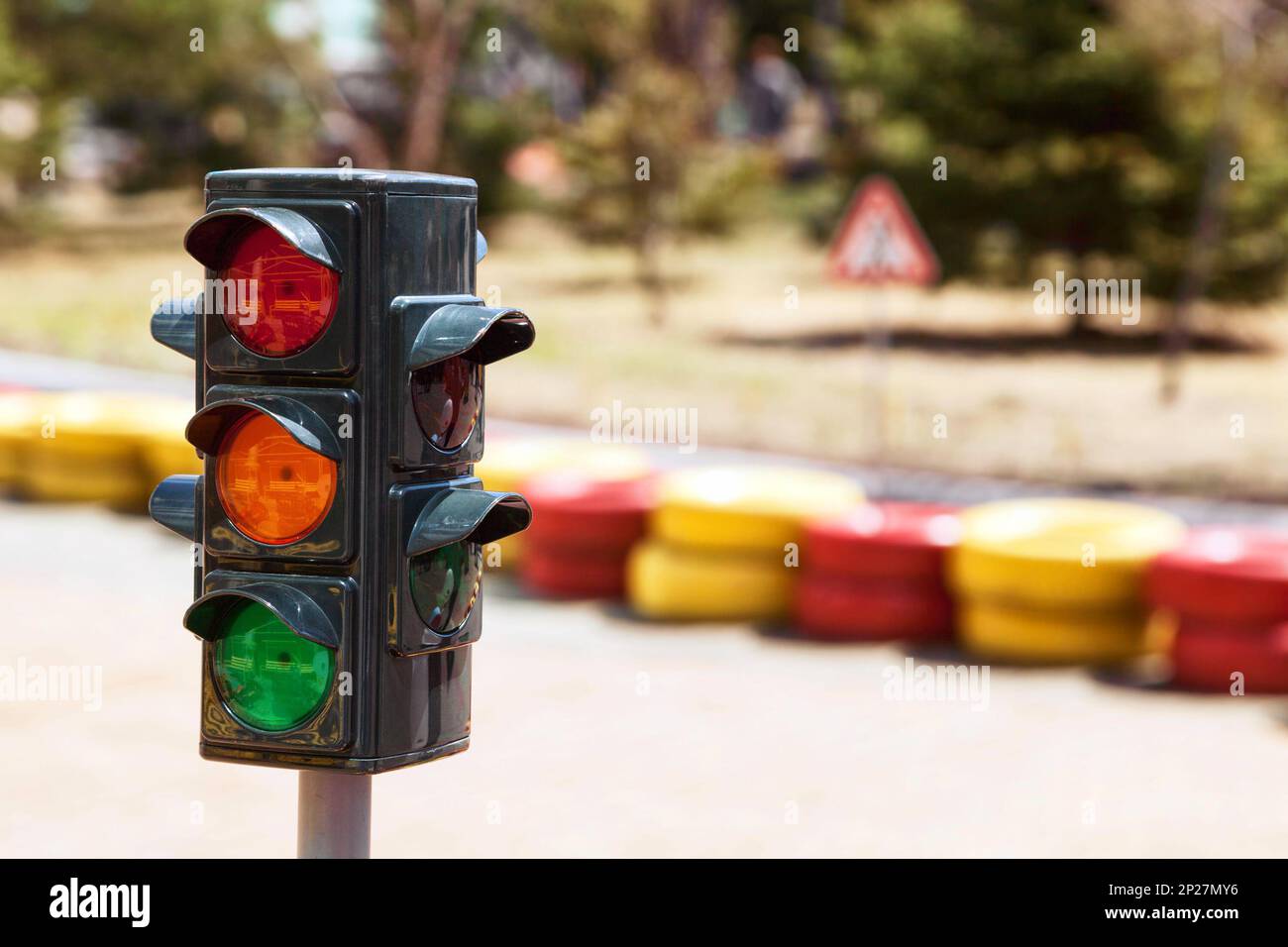 Small traffic light toy for kids learning street rules at kindergarten. Road safety education game for children Stock Photo