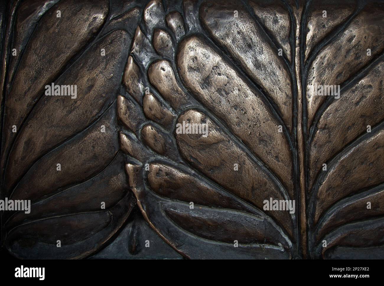 Big leaves close-up macro dark bronze metal relief background. Vintage water lily sculpture foliage art Stock Photo