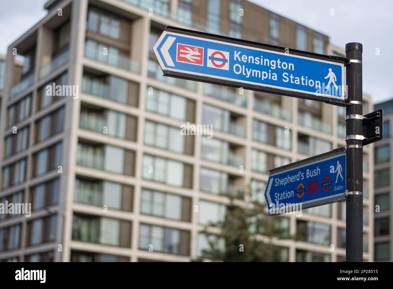 A road sign on a street in London gives directions to pedestrians