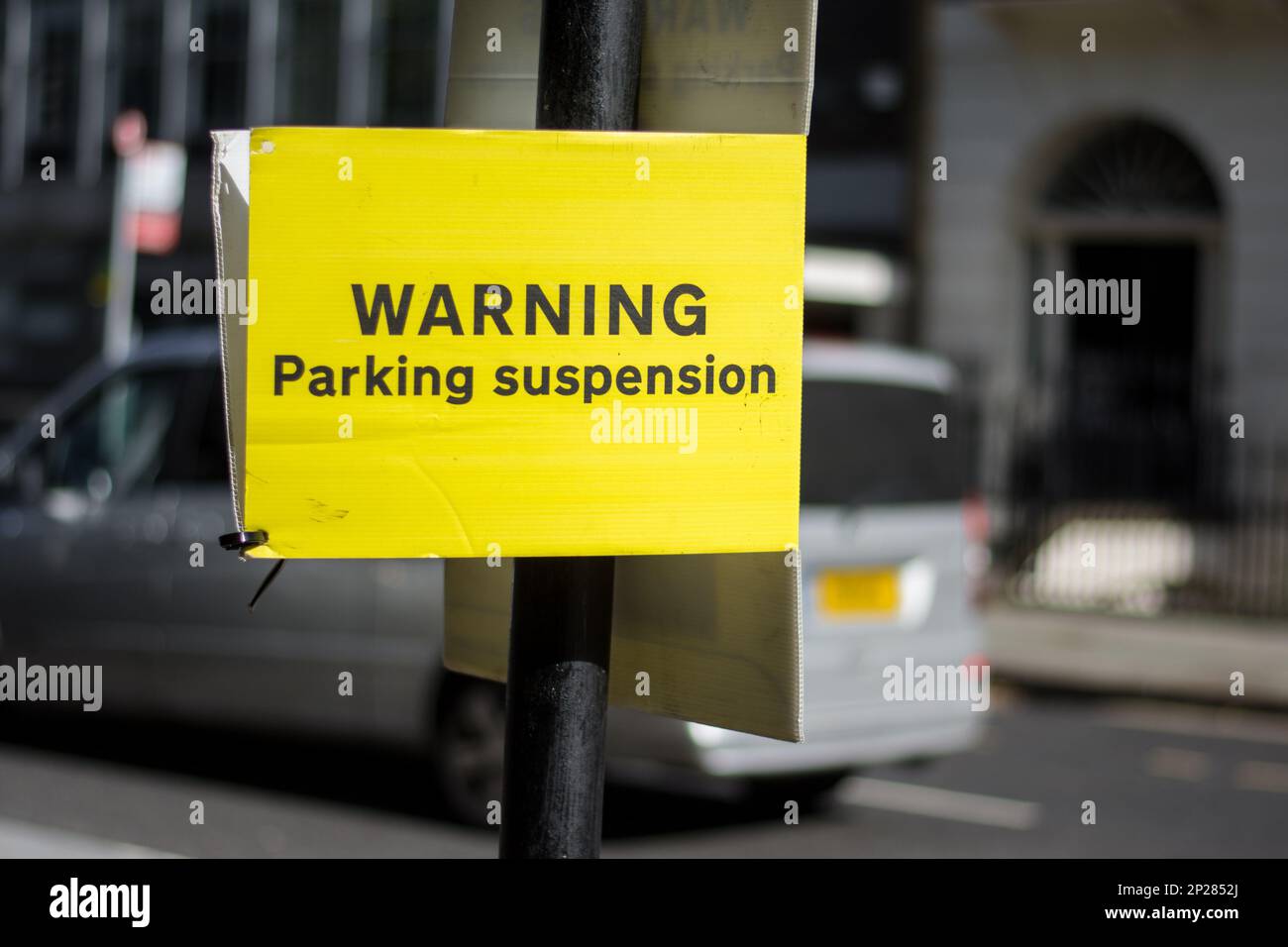 A yellow street sign alerts drivers that the parking area is closed and