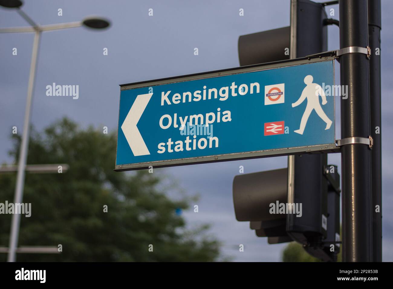 A road sign in London, UK gives directions to Kensington tube station