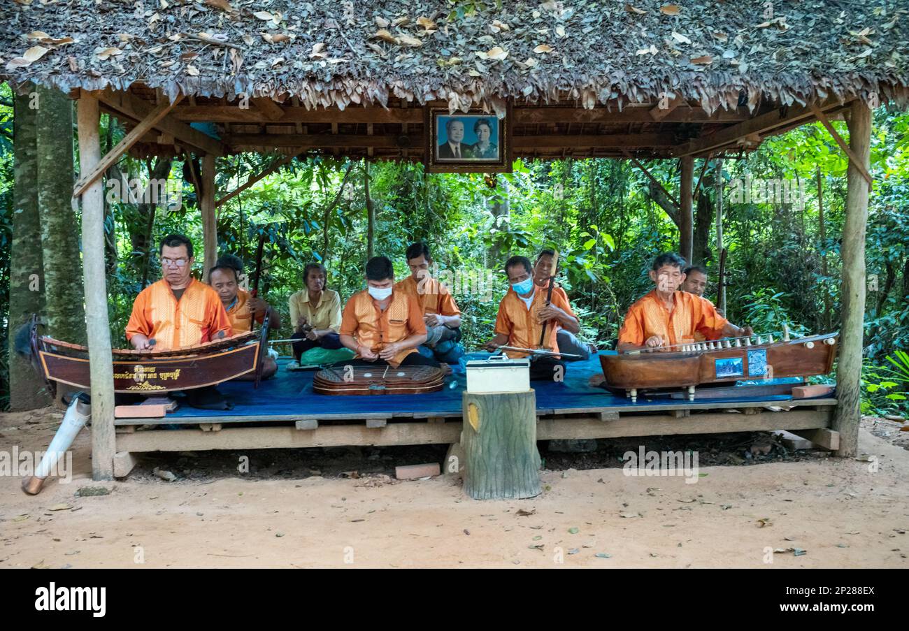 A group of men disabled by landmines play traditional Cambodian music at Banteay Srey temple in Angkor, Cambodia. Stock Photo