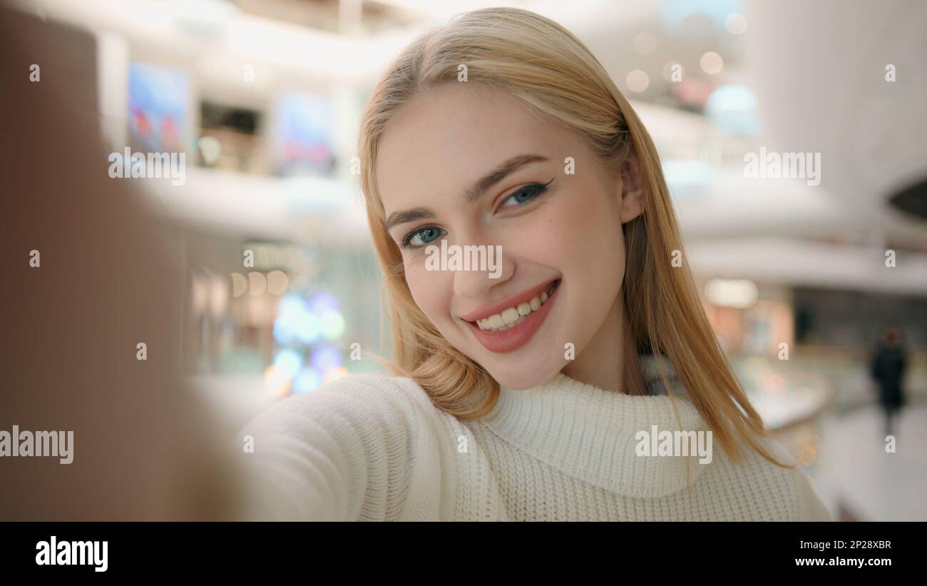 Webcam view blogger Caucasian woman lady shopper blonde girl record blog in  shopping mall online video streaming for social media looking at mobile  Stock Photo - Alamy