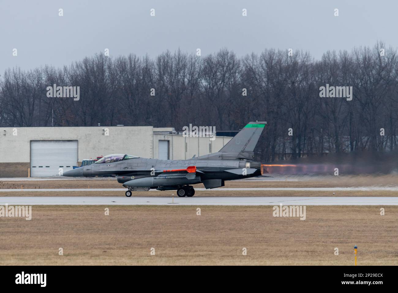 A U.S. Air Force F-16 Fighting Falcon, assigned to the Ohio National Guard’s 180th Fighter Wing, takes off for a training flight at the 180FW in Swanton, Ohio, Jan. 8, 2023. The 180FW is the only F-16 fighter wing in the state of Ohio, whose mission is to provide for America; protection of the homeland, effective combat power and defense support to civil authorities, while developing Airmen, supporting their families and serving in our community. Stock Photo