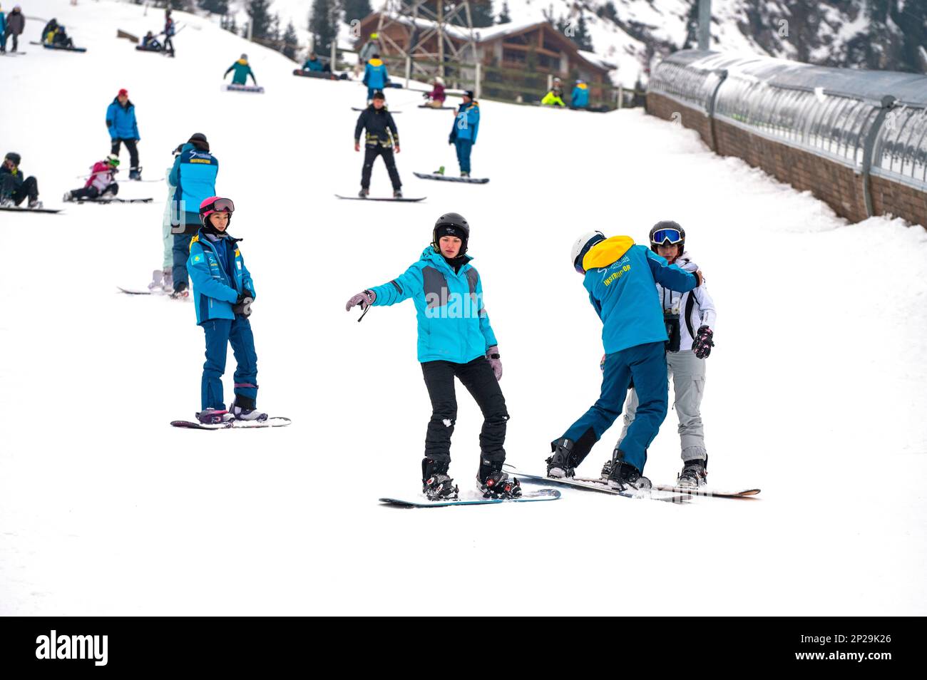 ALMATY - FEB 16: People snowboarding at Shymbulak or Chimbulak ski resort with instructors near Almaty on February 16. 2023 in Kazakhstan Stock Photo