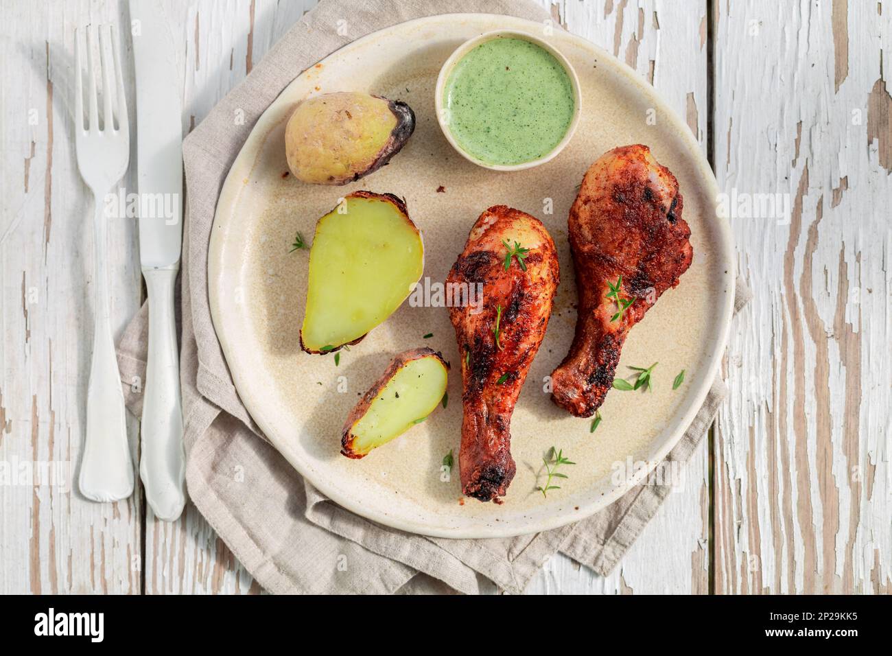 Top view of roasted chicken on rustic white table in summer Stock Photo