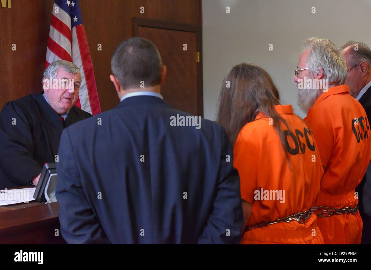 Bruce Leornard, right, and Deborah Leonard, second from right, stand in