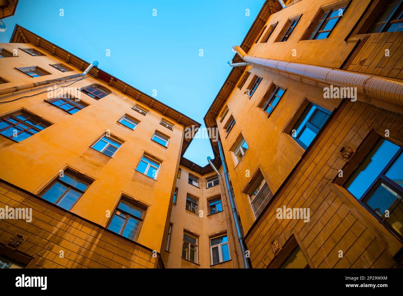 Traditional Court yard or well with bright yellow building in Saint-Petersburg, Russia Stock Photo
