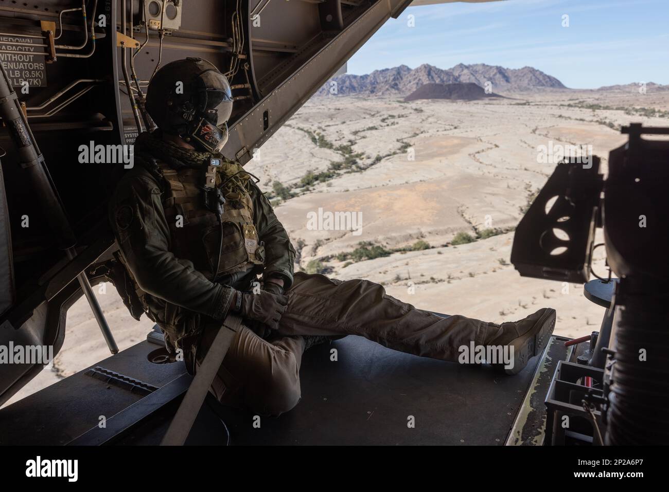 U.S. Marine Corps Sgt. Brady Wulf, an MV-22B Osprey crew chief with Marine Medium Tiltrotor Squadron (VMM) 261, provides rear line of sight to pilots over Holtville, California, Jan. 18, 2023. VMM-261 trained to support Marine ground units during Service Level Training Exercise 2-23, a series of exercises designed to prepare Marines for operations around the globe. VMM-261 is a subordinate unit of 2nd Marine Aircraft Wing, the aviation combat element of II Marine Expeditionary Force. Stock Photo
