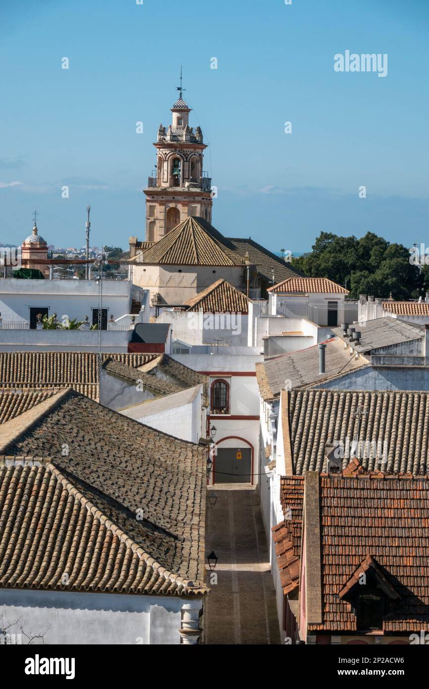 Typical street of Sanlucar de Barrameda, Spain, with the church tower in the background Stock Photo