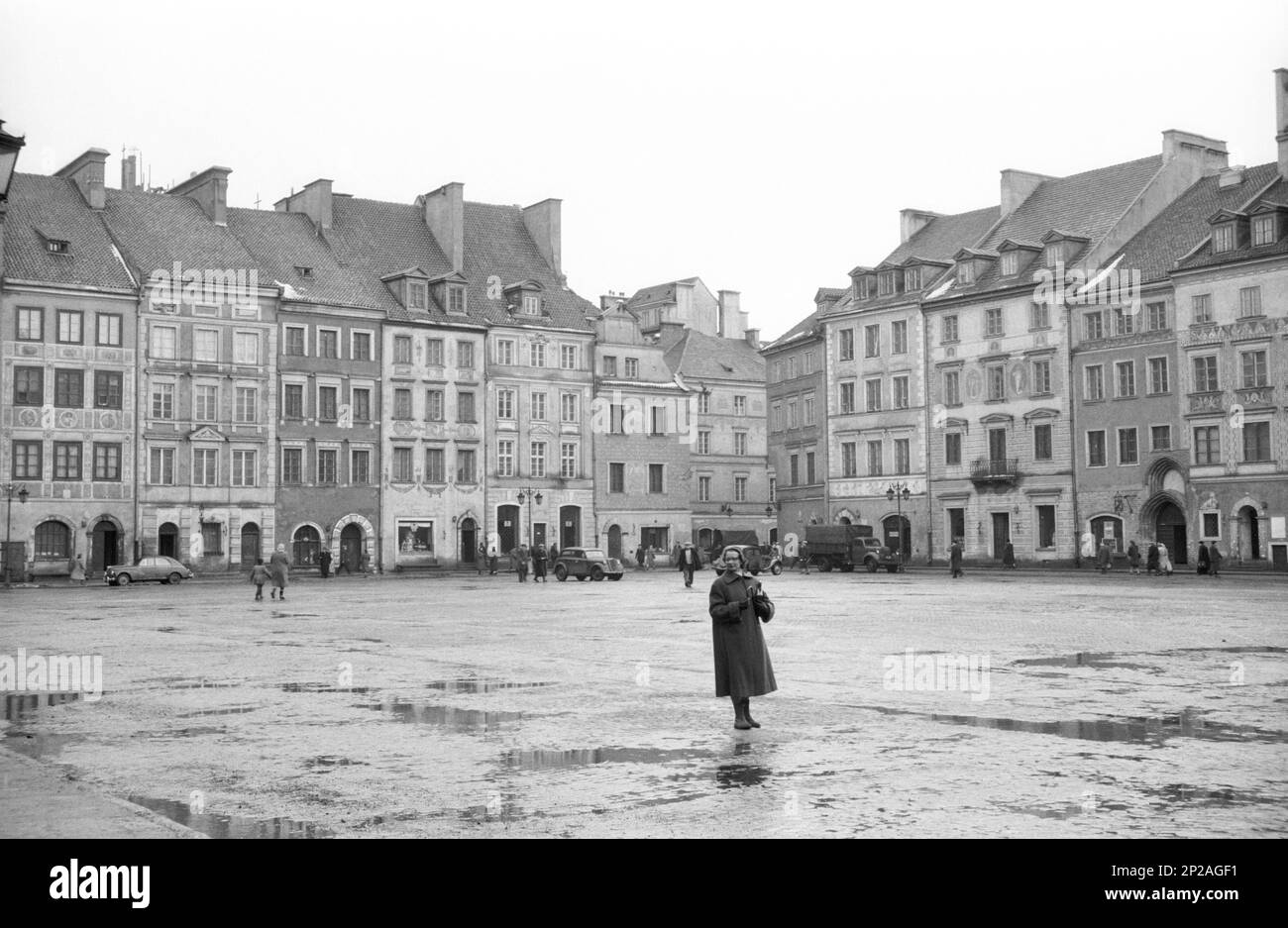 A woman stands on the Old Town Market Place, historic centre of Warsaw, Capital City of Warsaw, Masovian Voivodeship, Poland, March 1956 Stock Photo