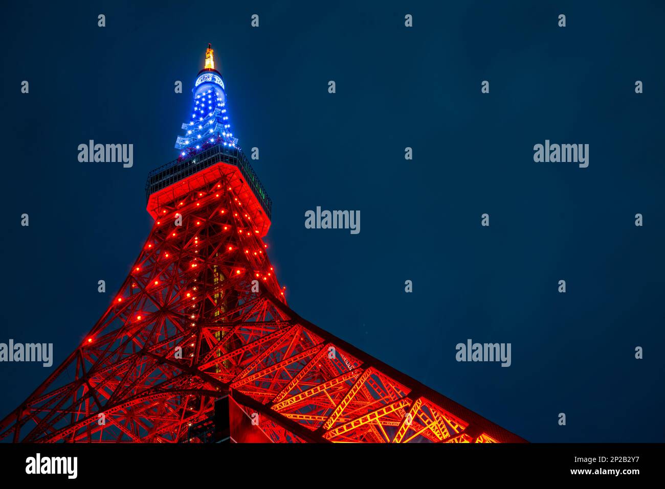 Tokyo Tower, an iconic landmark of Japan, stands tall in the heart of Tokyo, illuminating the city skyline with its striking red and white steel struc Stock Photo