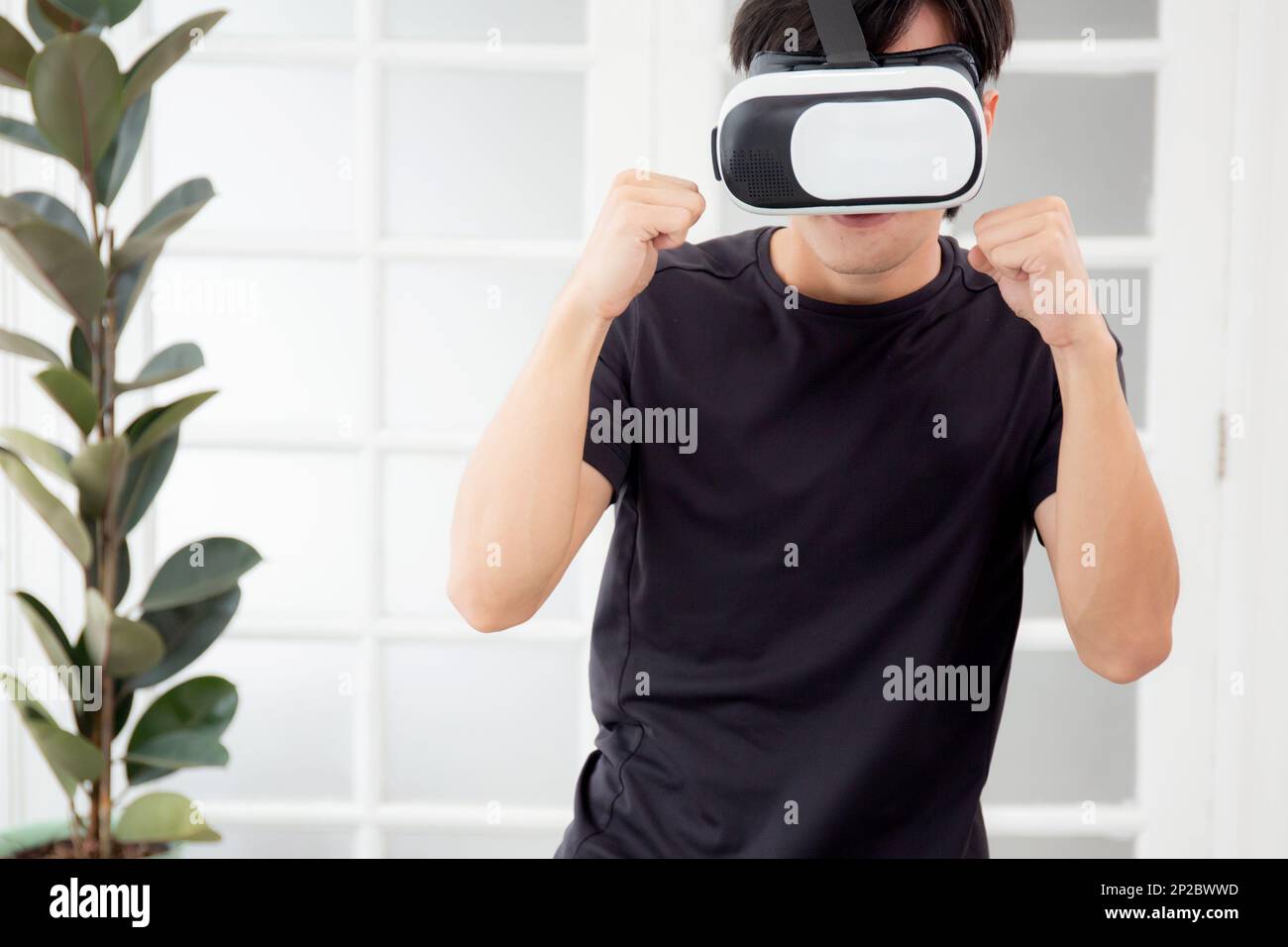 Young asian man wearing vr headset while workout and exercise at living