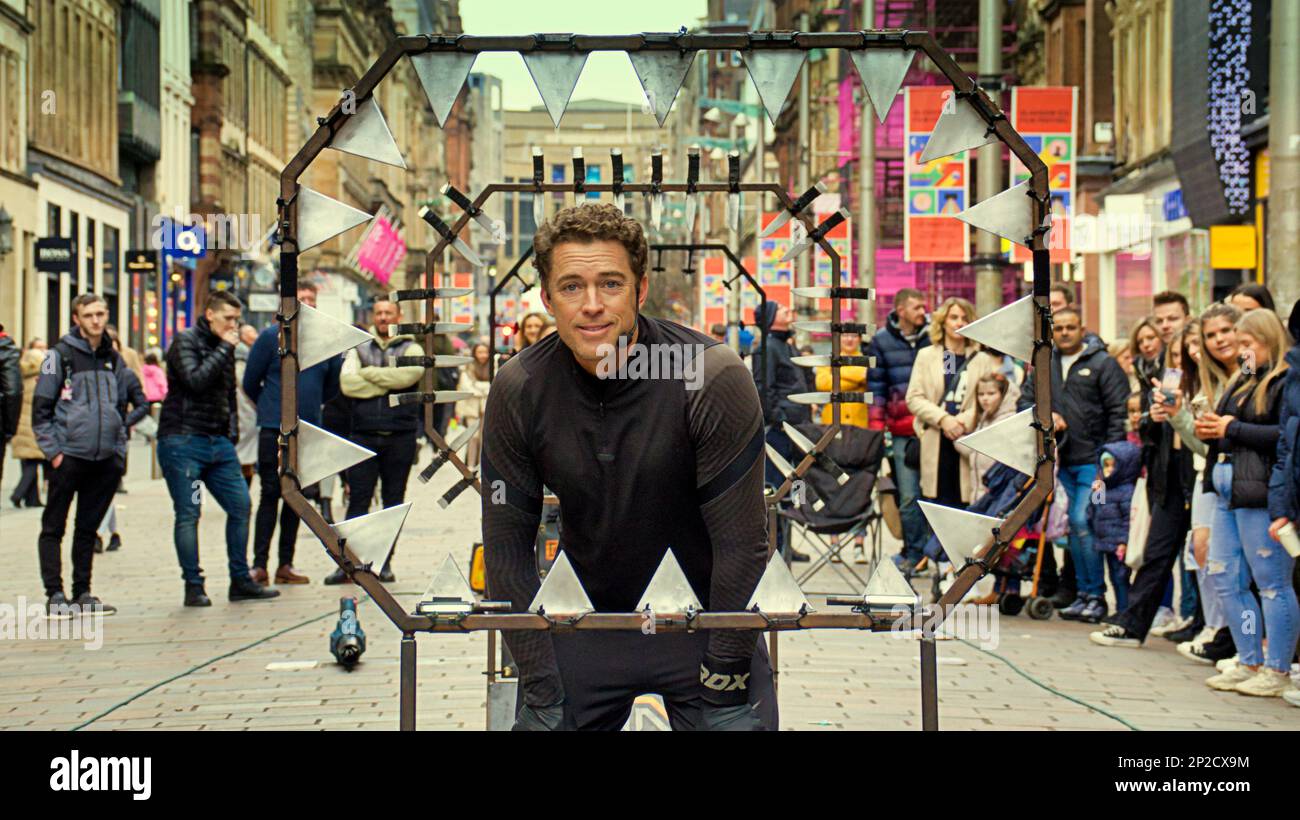 Glasgow, Scotland, UK 4th March, 2023. UK Weather:  Spring sunshine saw locals take to the streets in anticipation of summer. On the style mile of buchanan street scotland's shopping premier site The Stunt Runner Liam Collins A Blindfolded daredevil hurdles through knives performs regularly on the street. Credit Gerard Ferry/Alamy Live News Stock Photo