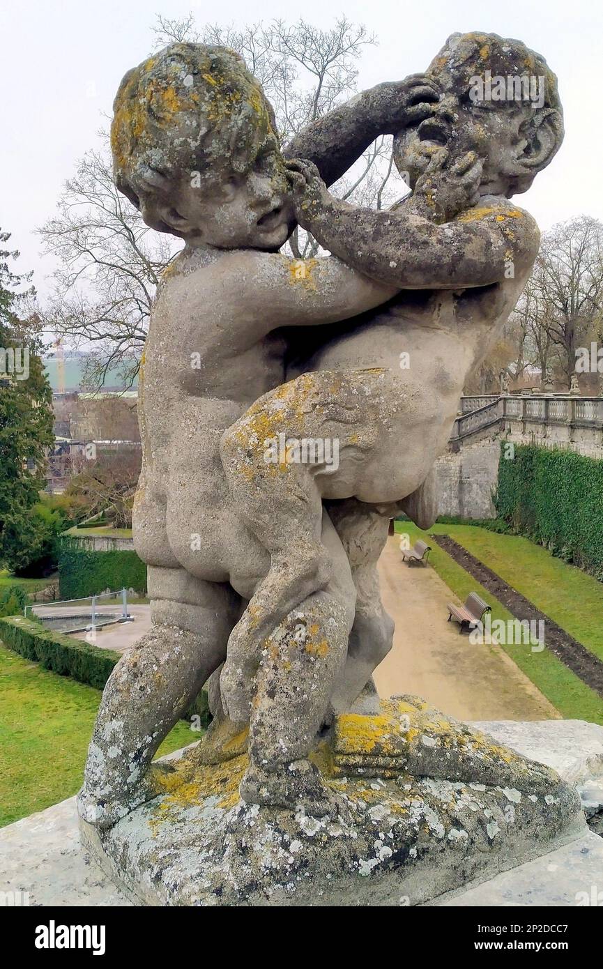 Sculpture of wrestling putti in the Court Gardens of the Residenz, 18th-century baroque Prince-Bishops Palace, Wurzburg, Germany Stock Photo