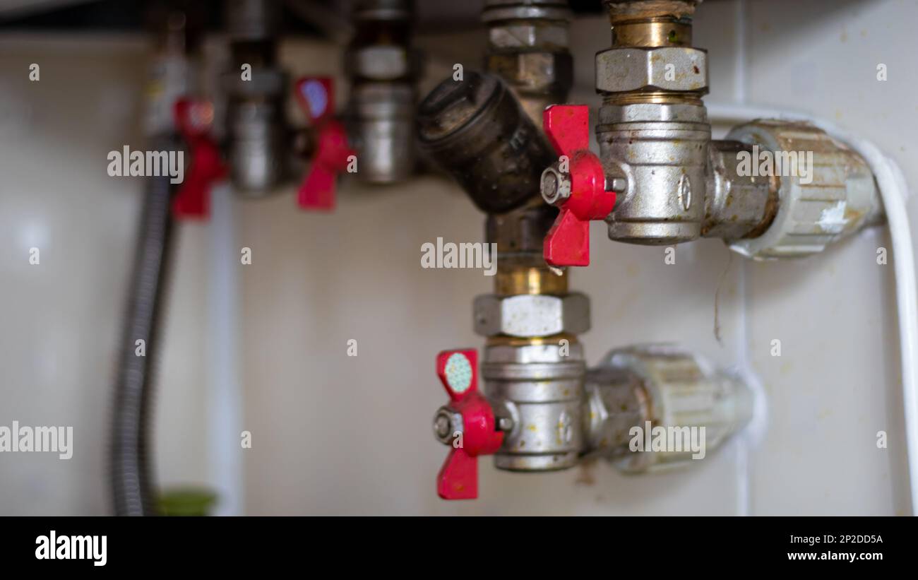 Hidden water taps for connecting a gas boiler on a tiled wall. Plumbing connections for a