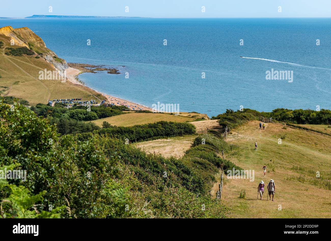 People walking uphill in Summer from Seatwon beach, Jurassic coast, Dorset, England, UK Stock Photo
