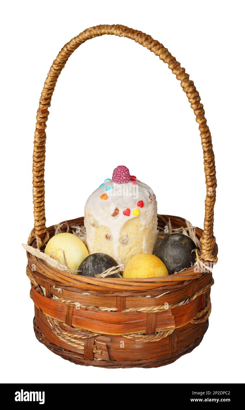 Basket with Easter cake and painted eggs on isolated white background Stock Photo
