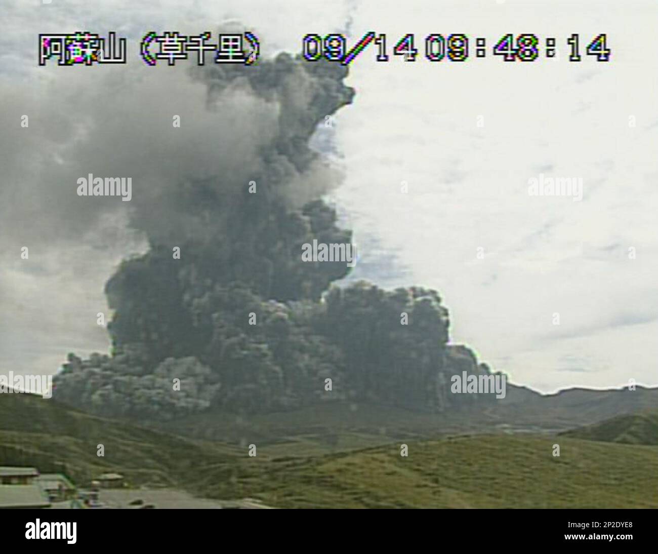 In this image taken from a surveillance camera observed from Kusasenri and  released by Japan Meteorological Agency, a column of black smoke rises from  Mount Aso, Kumamoto prefecture, southern Japan Monday, Sept.