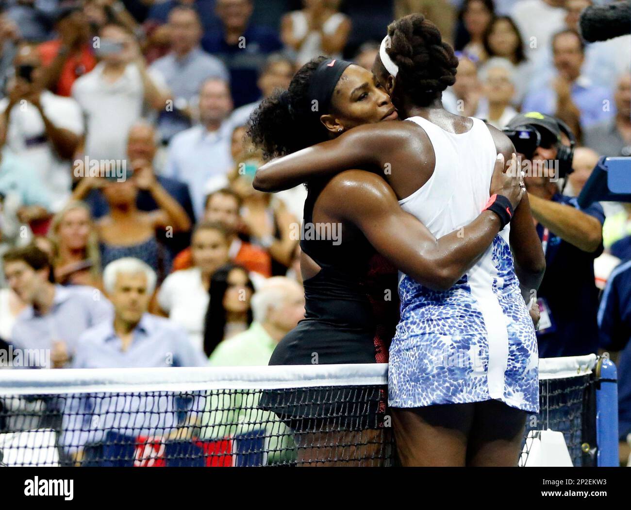 Serena Williams, left, hugs Venus Williams after winning their