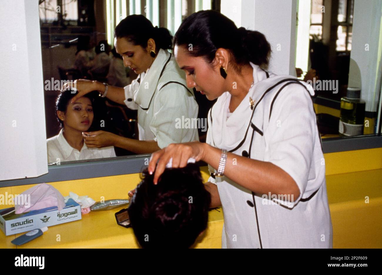 Saudi Arabia Make Up Artist Applying Make Up On Girl at Cabin Attendant training Stock Photo