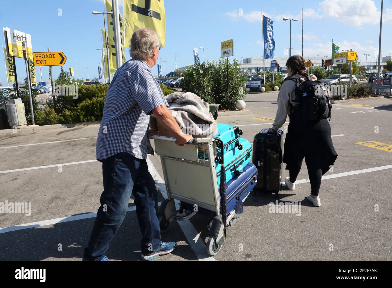 Athens Greece Touristswith Luggage in Airport Trolley at Car Rentals by Athens International Airport (AIA) Eleftherios Venizelos Stock Photo