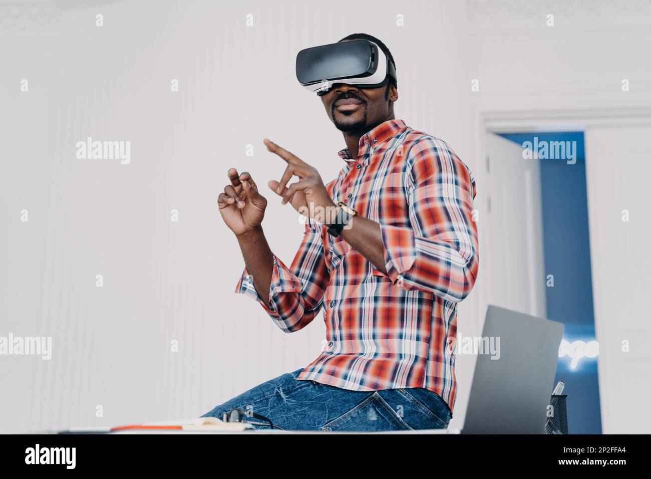 Happy african american guy in vr goggles at home. Young businessman has ...
