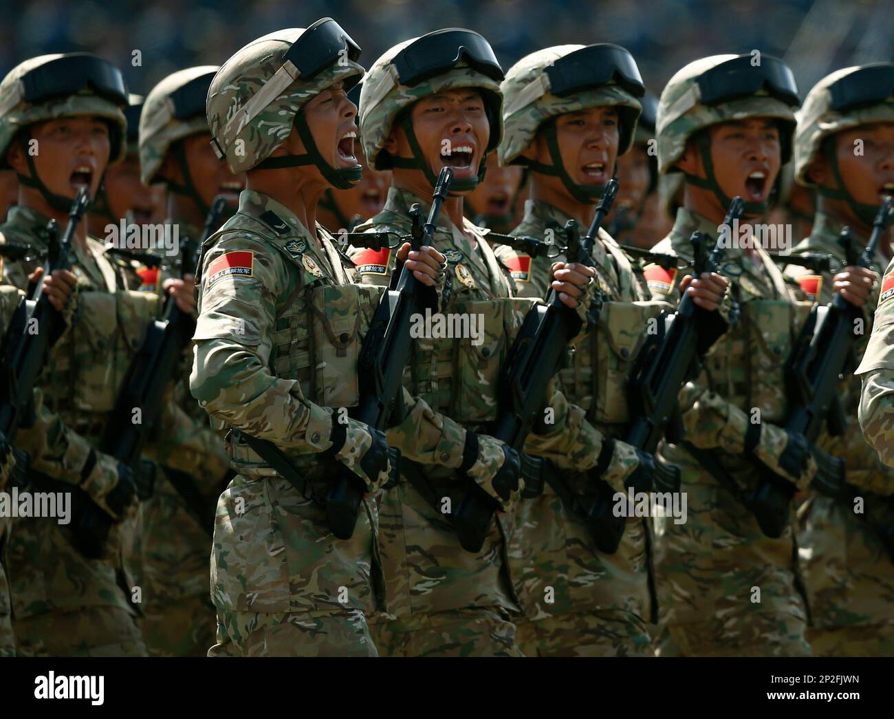 Chinese soldiers yell out as they march during a parade commemorating ...