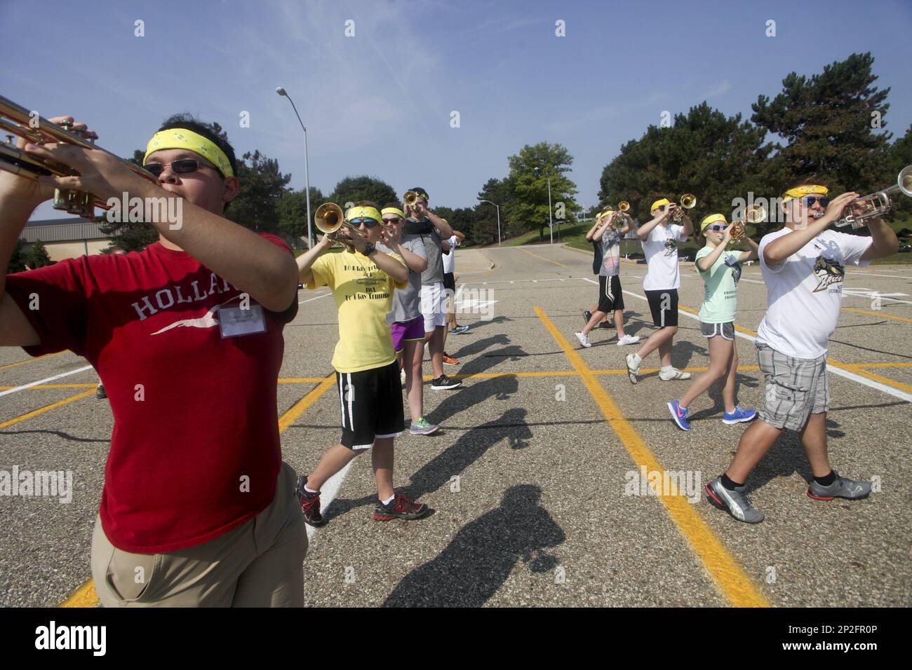 Members of the Bronco Marching band practice in sectionals in
