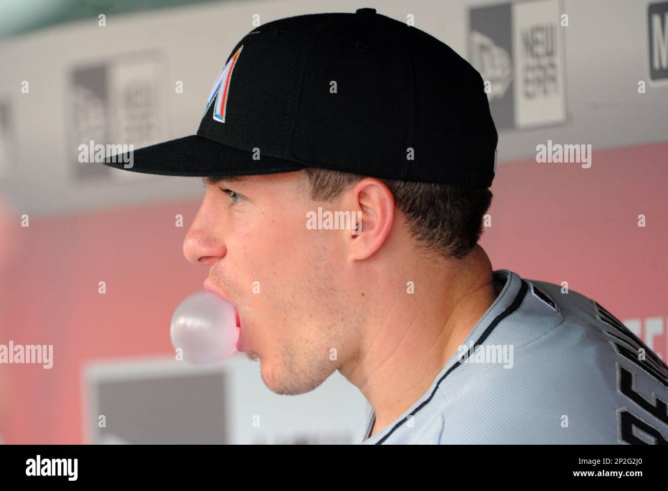 30 August 2015: Miami Marlins catcher J.T. Realmuto (20) blows a bubble in  the dugout against the Washington Nationals at Nationals Park in  Washington, D.C. where the Washington Nationals defeated the Miami