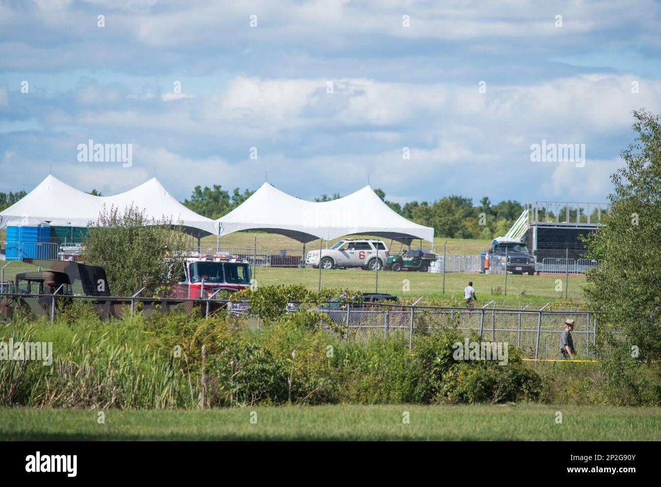 New York State Troopers walk the perimeter of the scene of a plane