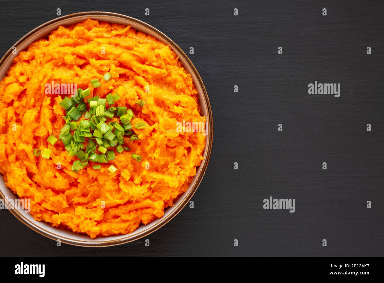 Homemade Creamy Mashed Sweet Potatoes with MIlk and Butter in a Bowl, top view. Copy space. Stock Photo