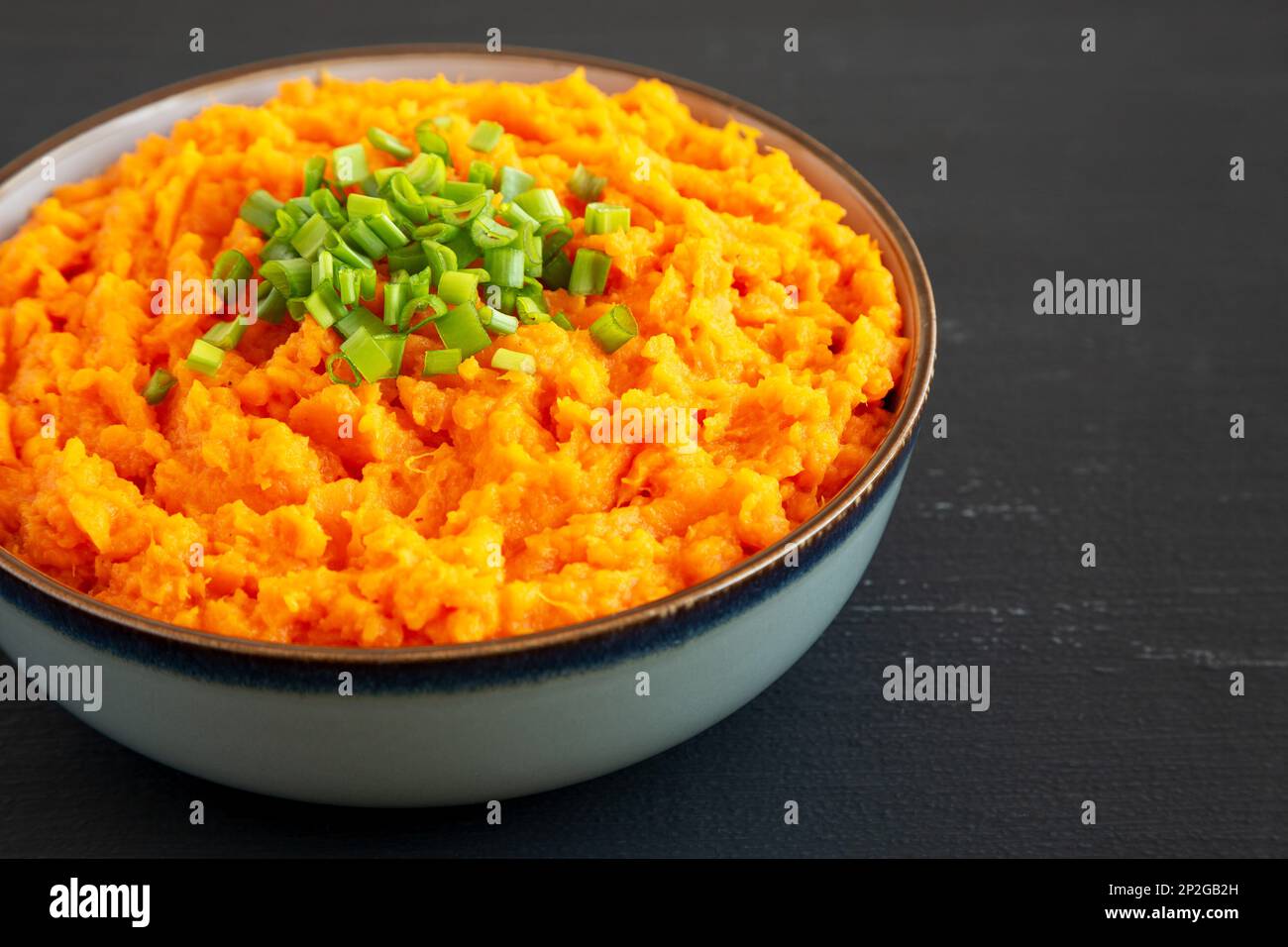 Homemade Creamy Mashed Sweet Potatoes with MIlk and Butter in a Bowl, side view. Copy space. Stock Photo