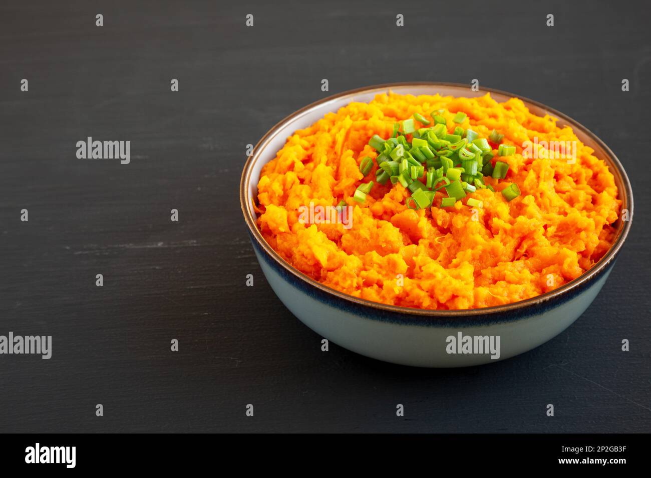 Homemade Creamy Mashed Sweet Potatoes with MIlk and Butter in a Bowl, side view. Copy space. Stock Photo