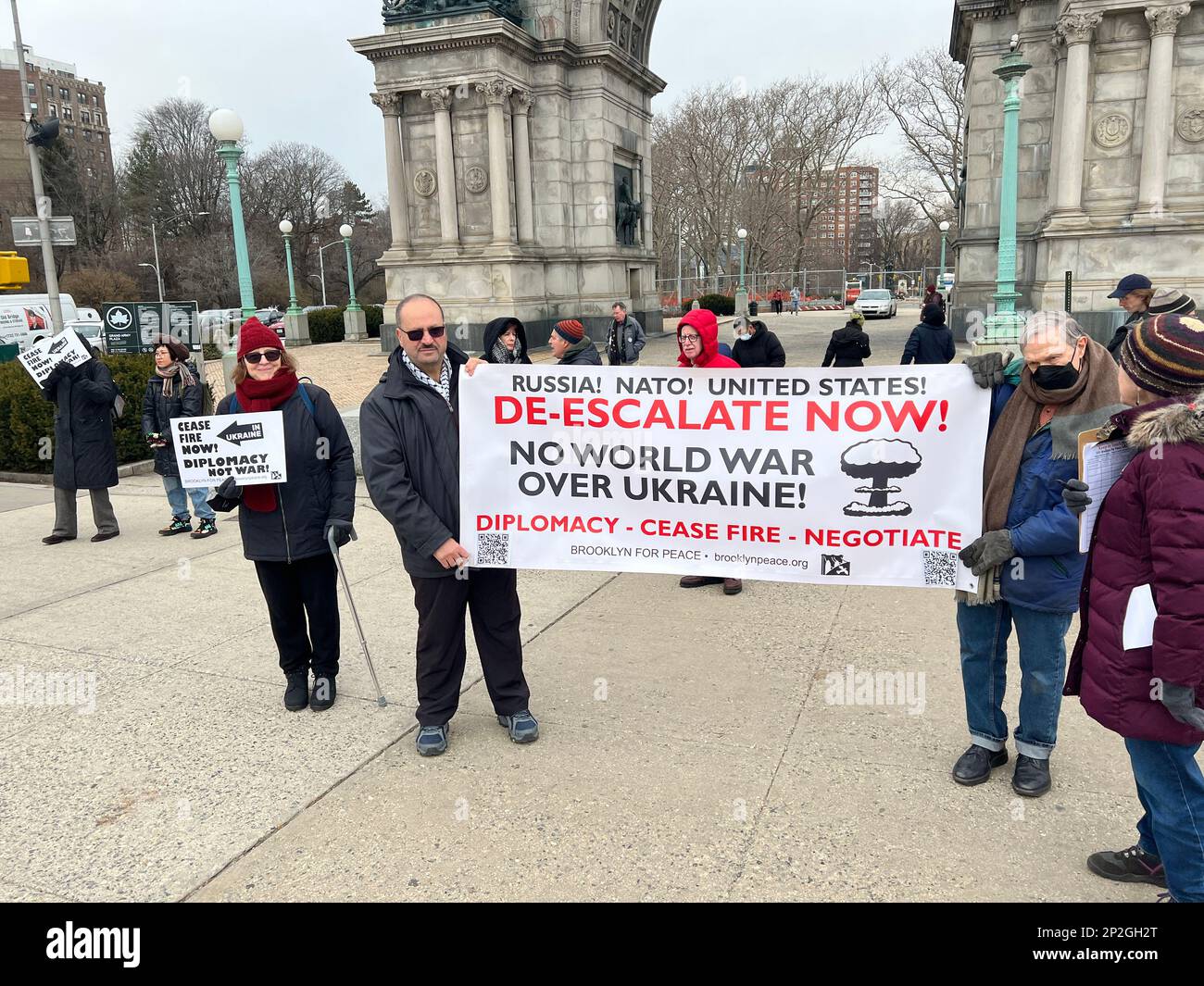 Antiwar demonstration to de-escalate the war in Ukraine and stop the slaughter of young men on both sides as well as civilians through negotiations and stop funding the military industrial complex. Rally at Grand Army Plaza in Brooklyn, New York. Stock Photo