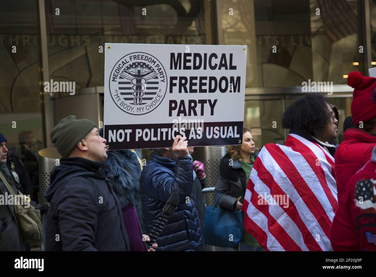 Medical Freedom Party members and others questioning the profit motives behind the quick production of the Covid vaccines demonstrate in front of Pfizer World headquarters on 42nd Street in Manhattan, New York City. Stock Photo