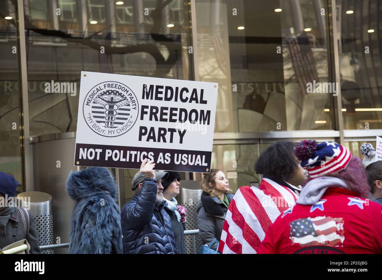 Medical Freedom Party members and others questioning the profit motives behind the quick production of the Covid vaccines demonstrate in front of Pfizer World headquarters on 42nd Street in Manhattan, New York City. Stock Photo