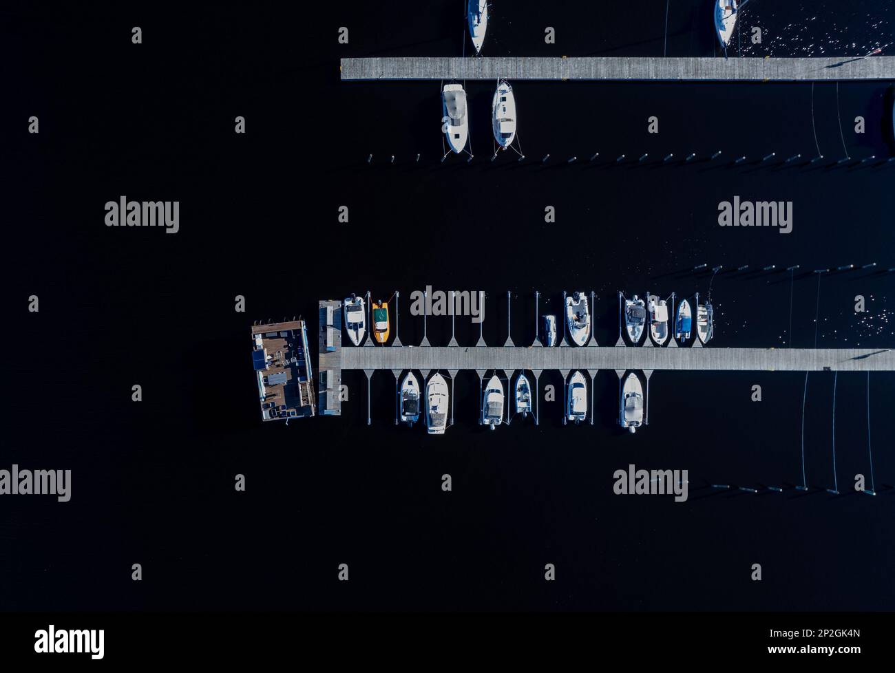 Aerial drone scenery of fishing boats and yachts moored at the marina ...