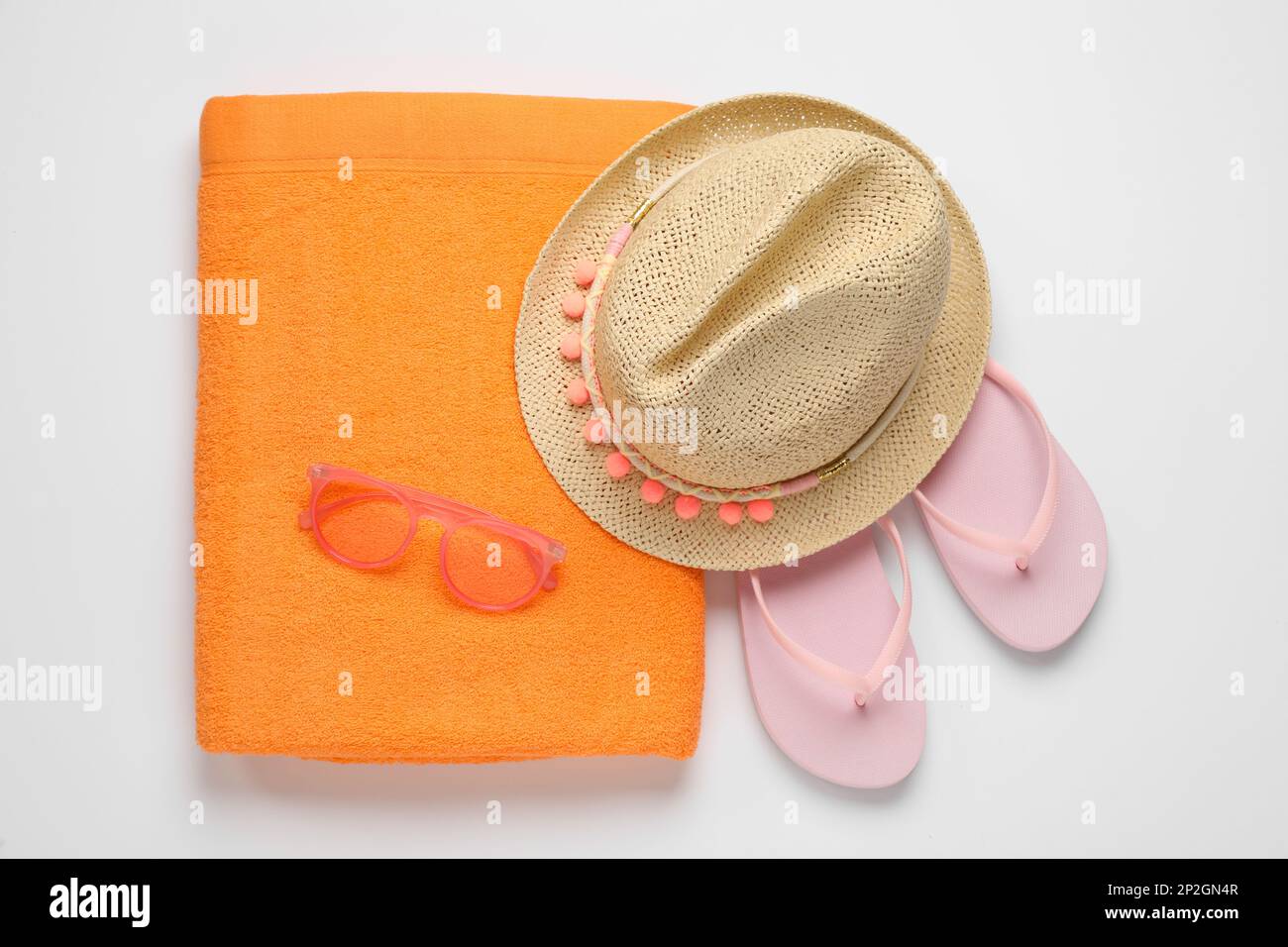 Beach towel, flip flops , sunglasses and hat on white background, top ...