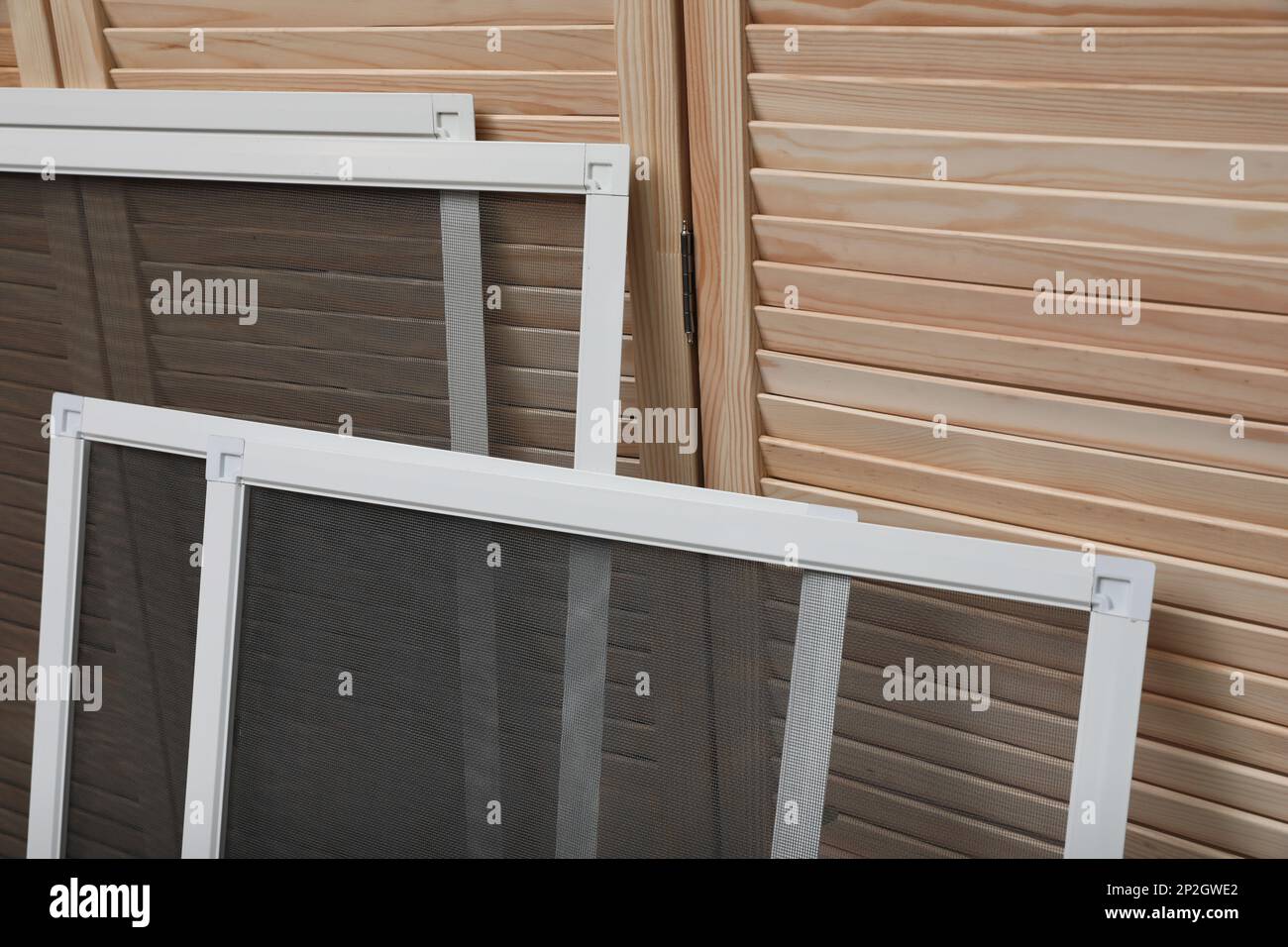 Set of window screens near wooden folding screen Stock Photo Alamy
